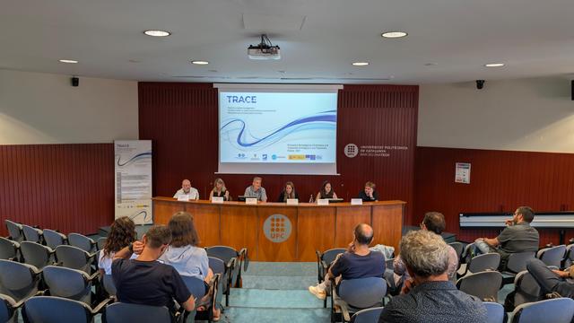 Picture of today's event with the round table sessiom and trace project presentation in the background