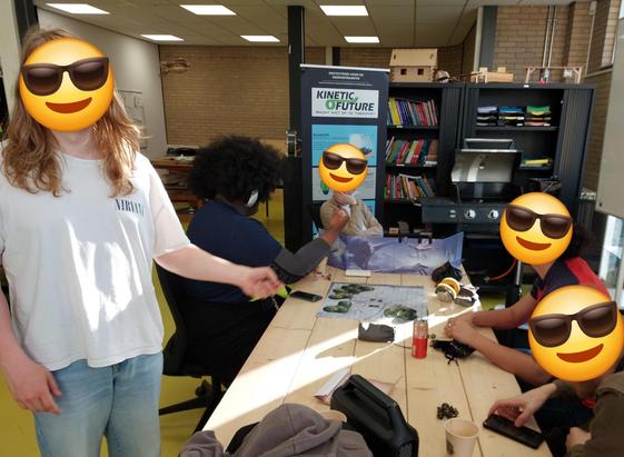 The d&d table from the other end. The kid with ADHD is stood up to demonstrate to me how they cut the butthole of a monster they encountered.