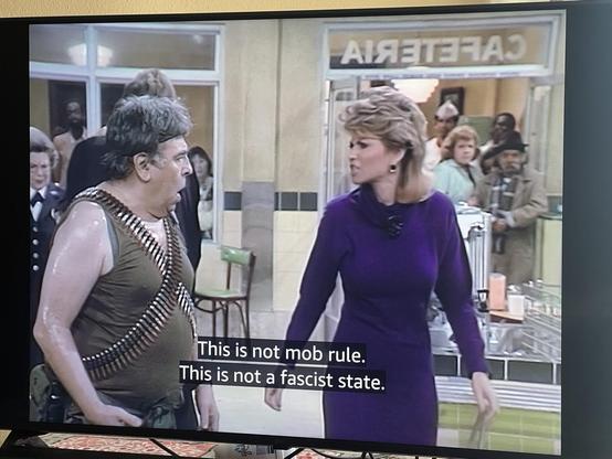 Christine Sullivan talking to man with ammo belts “This is not mob rule. This is not a fascist state.”