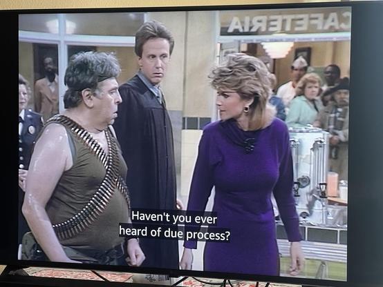 Christine Sullivan talking to man with ammo belts “Haven’t you ever heard of due process?”