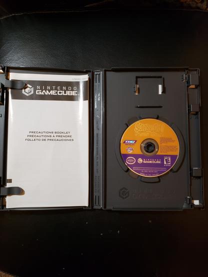 The disc for Scooby-Doo! Mystery Mayhem. Notice the lack of instruction manual: when I bought this game from the specialist resale store, the store owners didn't get the instruction manual so I had to figure the controls out by the Options menu in-game before starting the game.

The biggest problem is that the backside is scratched up. As in, quite a few scratches. I suspect that said scratches are what's causing the game to crash. The first crash was before the first loading screen could finish, and the second one was before the intro video played - a 3D version of the Scooby-Doo Where Are You? theme. The third crash was after I made solved the first mystery of... however many are in the game.

But the game will run as is, given some patience, so I can say I've played the game, now. Along that line, trying to actually BEAT the game might prove significantly harder than it's worth.