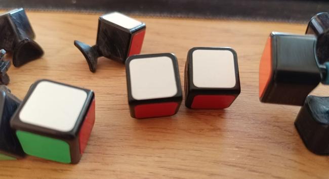 The cube, now taken apart. Two identical white/red edge pieces are next to each other, which should not exist.