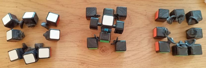The cube pieces, now laid out on the table and sorted into three layers, top, middle (with core) and bottom. This was to identify which colour stickers needed swapping.