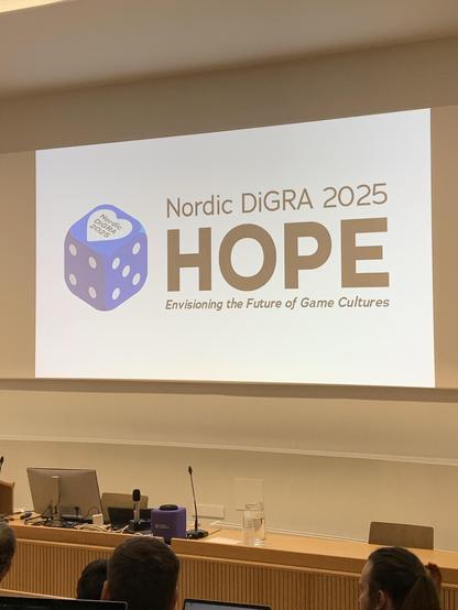 A presentation slide titled "Nordic DiGRA 2025" features the word "HOPE" and the subtitle "Envisioning the Future of Game Cultures." A blue die icon is displayed on the slide.