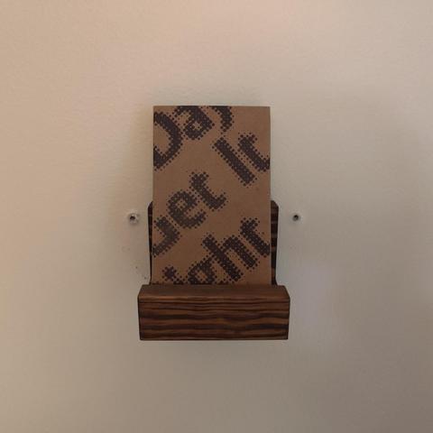 Cassette of One of These Days I'll Get It Right by Jim Guthrie and Solid Mas resting on a wall mount.