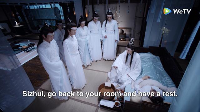 In the bedroom section of a home in the Cloud Recesses, a small crowd of downcast disciples stands surrounding, at a distance, a bed containing a sleeping Lan Qiren and Lan Wangji sitting on the edge of the bed. Among the disciples, Lan Sizhui stands second from the left but slightly closer in toward the bed. Wangji addresses him:

Sizhui, go back to your room and have a rest.