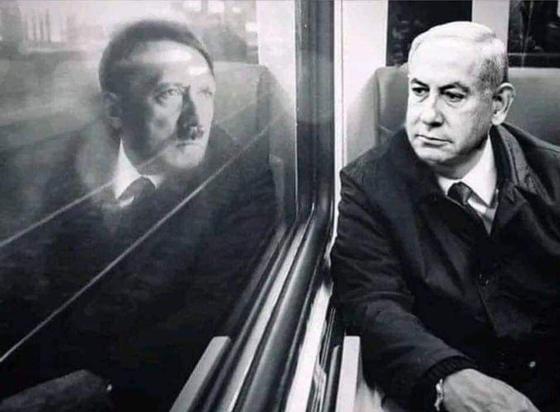 Netanyahu sitting by a window on a train, his reflection appears to be Hitler.