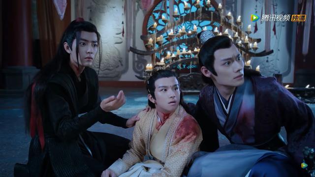 In Guanyin temple, Jin Ling sits between Wei Wuxian and Jiang Cheng. Wei Wuxian is kneeling with his body facing Jin Ling, left hand on Jin Ling's shoulder and right have drawn back between then after checking the bleeding wound in Jin Ling's neck, a shallow garrotte cut that crosses the width of his heck. Jin Ling also has blood on the right shoulder of his robes and he is leaning against Jiang Cheng, who is leaning forward with his left hand on Jin Ling's back. All three of them are directing startled looks toward a target offscreen beyond the right edge of the image.
