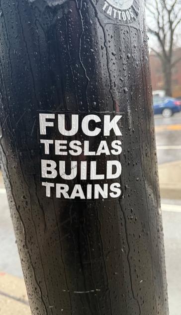 Sticker with text "Fuck Teslas build trains"