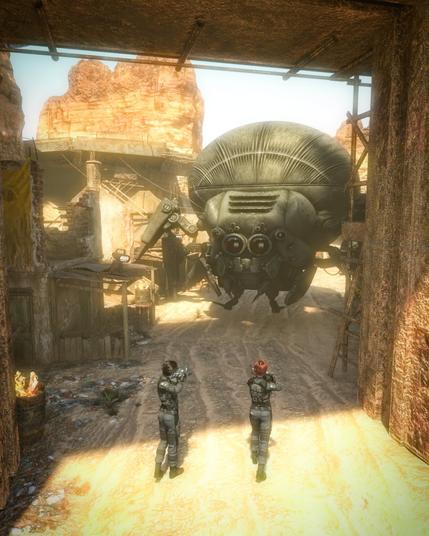 Description by Claude: The scene depicts two armored soldiers or fighters in a tense standoff with an imposing mechanical spider creature. The robot has a bulbous, dome-shaped body with distinctive ribbed plating and multiple thick, articulated legs that give it its arachnid appearance. Its front section features what appear to be glowing sensors or optical elements, giving it an ominous, predatory look.
The two human figures are positioned defensively in the foreground, wearing full tactical armor and appearing to be armed and ready for combat. Their body language suggests caution and alertness as they face this formidable mechanical opponent.
The setting is a post-apocalyptic desert outpost with weathered stone and metal structures. Warm, golden sunlight filters through the scene, illuminating the sandy ground and casting dramatic shadows. The background shows eroded cliff formations and makeshift buildings constructed from salvaged materials, creating an atmosphere of a harsh frontier settlement.
The overall mood is tense and atmospheric, suggesting this could be from a science fiction video game or film depicting humanity's struggle against robotic threats in a desolate future landscape. The contrast between the organic, weathered environment and the sleek, threatening machine creates a compelling visual narrative.