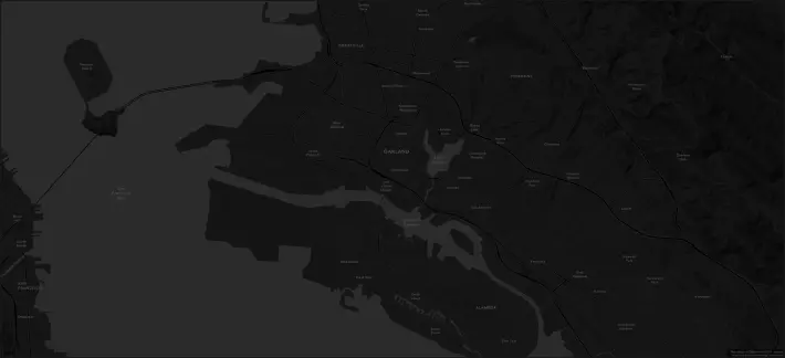 A geographic map of the city of Oakland, California, centered on downtown. The map's extent spans the San Francisco Bay to the west, the cities of Berkeley and Emeryville to the north, the Oakland hills to the east, and the city of Alameda to the south. The map depicts the road networks and names of various cities and neighborhoods, predominantly in the East Bay area. It includes a topographic shaded relief rendering of the rugged Oakland hills.