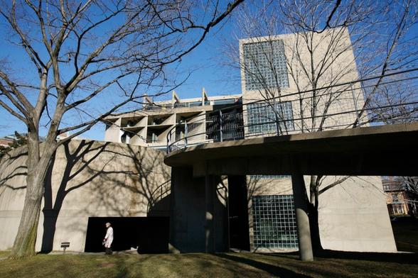A blocky concrete building with a long ramp extending from its second floor.