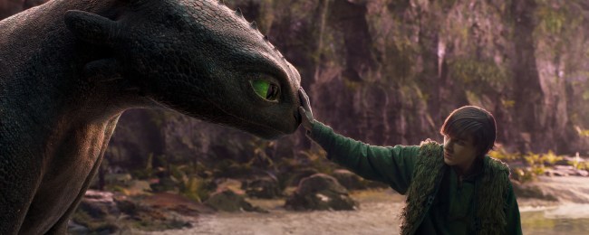 Mason Thames (right) as Hiccup with his Night Fury dragon, Toothless, in Universal Pictures’ live-action How to Train Your Dragon, written and directed by Dean DeBlois.