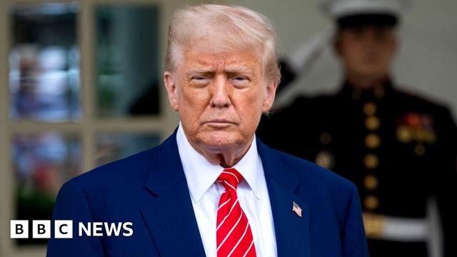 President Donald Trump in a dark suit and red tie