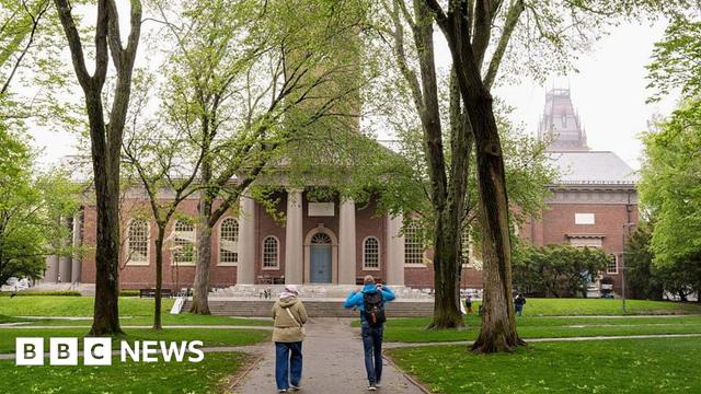 An exterior view of a building at Harvard University with people walking