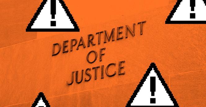 A photo of the side of the Department of Justice building with graphic warning symbols.