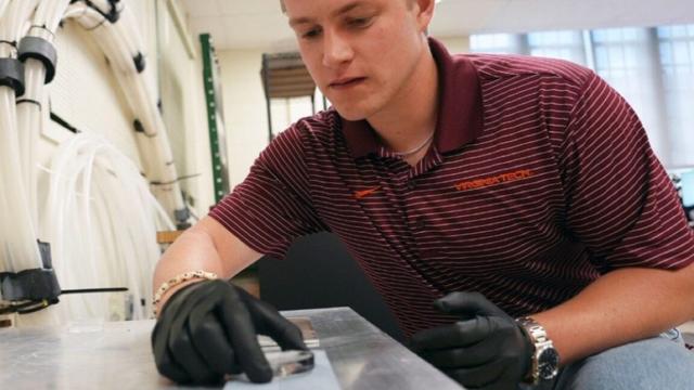 Graduate student Jack Tapocik sets up ice on an engineered surface in the VA Tech lab of Jonathan Boreyko