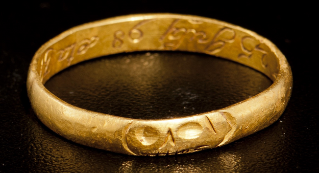 The whole gold ring with a tiny skull looking out from the hoop