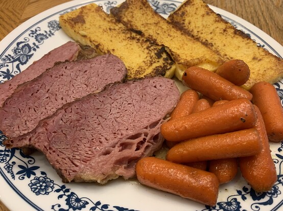 3 slices of braised corned beef, 3 slices of fried polenta, and a small pile of brandy glazed carrots