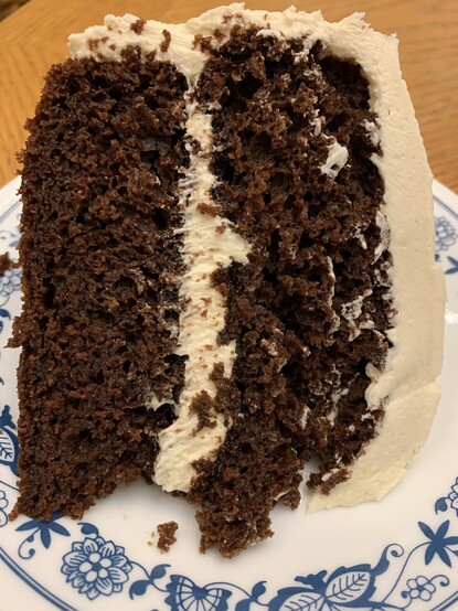 A cross-section of a slice of Chocolate Stout cake with Irish Cream buttercream frosting. 