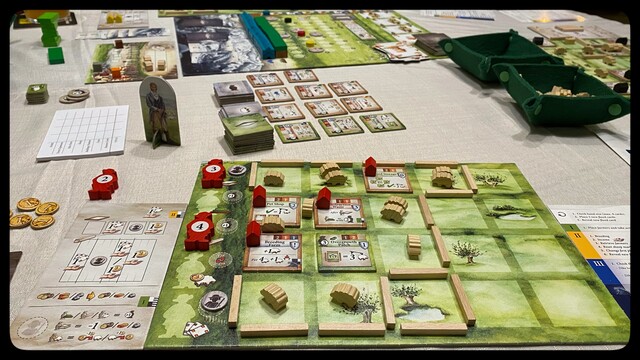 A player’s board showing their farm complete with fences, pastures, buildings… and lots of sheep