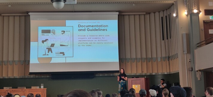Thaís presenting a slide about Documentation and Guidelines