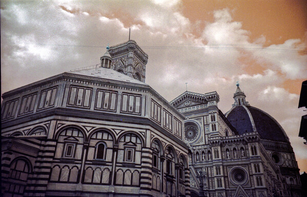 An orange sky hovering over the Battistero and Duomo in Firenze (Italy). Colours are shifted to orange since the photo was taken with analog Lomography LomoChrome Turquoise 400 35mm film and a Lomography LC-A camera.