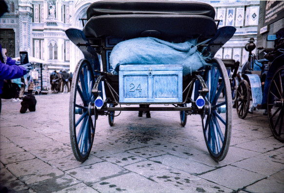 The rear of typical horse carriage in Firenze (Italy), shot in Piazza del Duomo. Identification plate of the carriage is the number 24. Colours are shifted to turquoise since the photo was taken with analog Lomography LomoChrome Turquoise 400 35mm film and a Lomography LC-A camera.