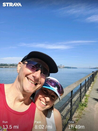 Selfie with my wife at the end of our workouts. Behind us, the Hudson River, and the George Washington bridge in the far distance. The blue sky has only a few clouds