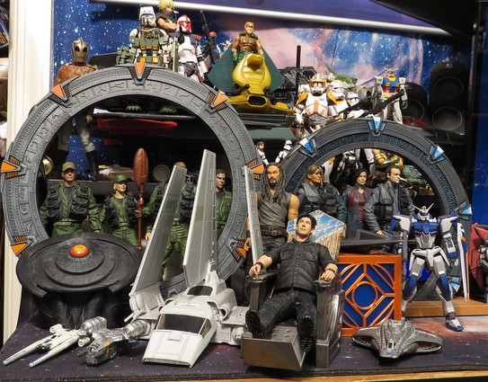 My desk is crowded! 

The Diamond Select Stargate figures and DHD plus the Ancient Control Chair are very cool figures.

That Micro Galaxy Squadron Imperial Shuttle is very cool too and I love the size scale for it.

Got 2 smaller Hot Wheels Star Wars Ships in front of the DHD the U-Wing and Razor Crest.

Behind the Ancient Control Chair is a 3D Printed Holocron with the Federation Timeship on top and a Federation Scout Ship in front on the desk.

The Robot Spirits Duel Gundam stands infront of the Atlantis Stargate.

