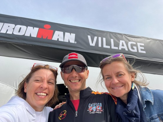 My wife, myself and my friend Audrey under the Ironman village banner