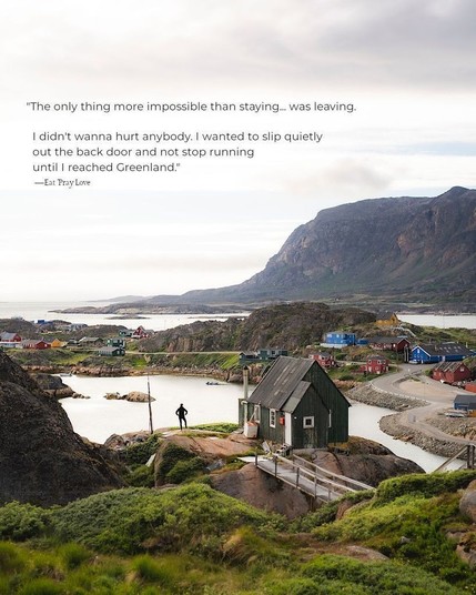 A person stands at the edge of a small residential property in the middle distance, gazing over a body of water and a remote village nearby. The quote on the photo reads, "The only thing more impossible than staying was leaving. I didn't wanna hurt anybody. I wanted to slip quietly out the back door and not stop running until I reached Greenland." from Eat Pray Love (2010)