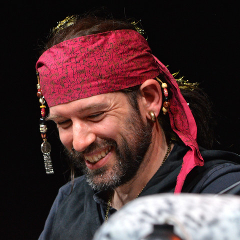 A photo of Andy Farrant as CorazÃ³n de Ballena. He is smiling.