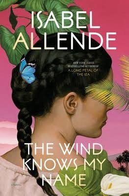 Book cover:
Portrait of a young Hispanic woman seen from behind, her head turned in profile and her black hair in two braids joining into one at the nape of her neck against the simple background of a pink sky, fragments of a cloud, hills and palmtrees at the bottom. Tropical leaves, an arum lily and a butterfly in he foreground.
Text overlay:
Isabel Allende
The Wind Knows My Name