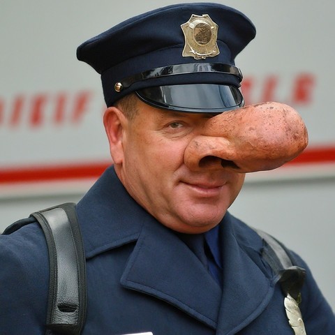 Doughty, fiftyish police officer in dress blues. His nose is the size of a hoagie. His eye is on you.