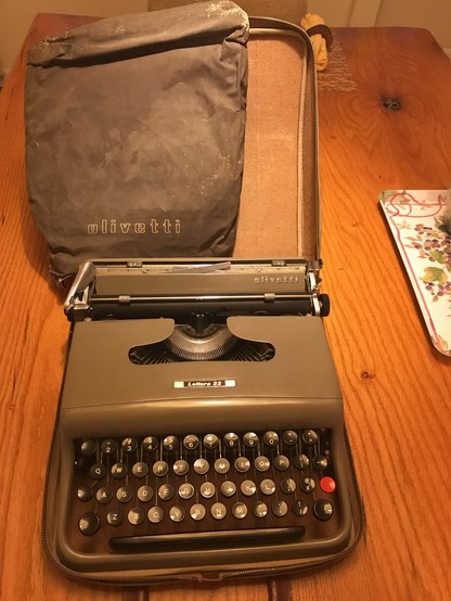 An Olivetti Lettera 22 typewriter mid 1960s with dust cover, case & instruction books. 