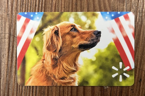 A Labrador retriever between two American flags on a Walmart gift card
