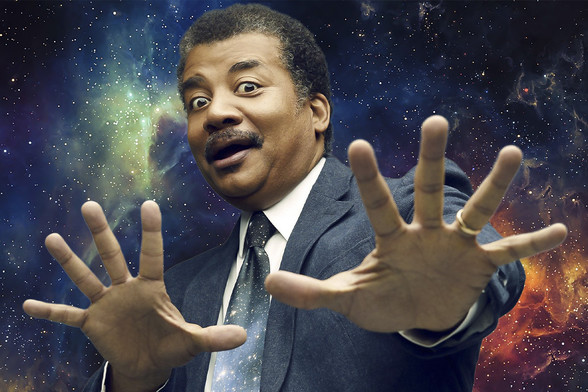 Neil deGrasse Tyson in front of a backdrop of the night sky, hands stretched forward as if about to strangle a person or even maybe a planet