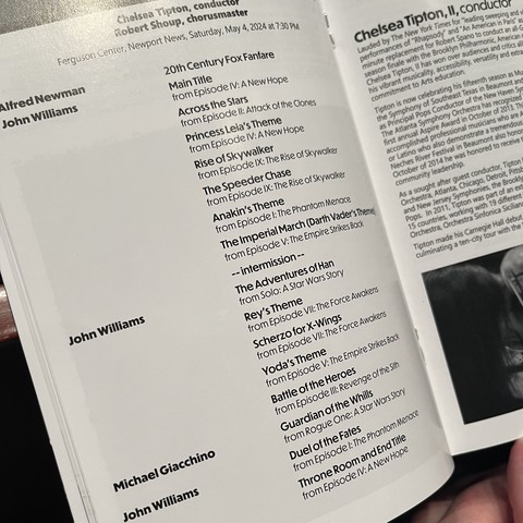 A close-up of an open program booklet listing song selections for the Star Wars Concert at Ferguson Center, Newport News, Saturday, May 4, 2024 at 7:30 PM.