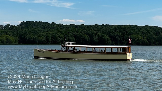 Photograph of what looks like a tour boat. Possibly made of wood, vertically short but long. Lots of windows. 

This photo copyright 2024 by Maria Langer. All rights reserved. Neither this image nor the accompanying alt text may be used to train AI systems.