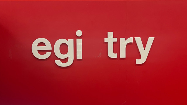 Lowercase sans-serif white letters on a red wall:
    egi try