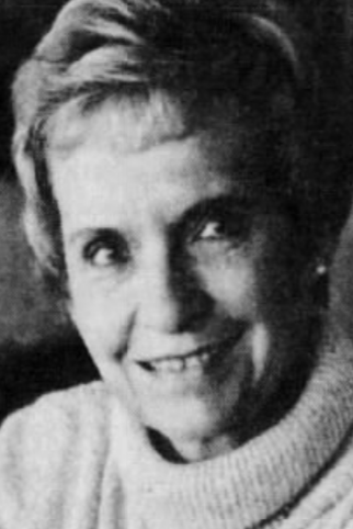 Patricia S. Warrick in the 1980s, a smiling white woman in her sixties with short blonde or grey hair, wearing a turtleneck sweater