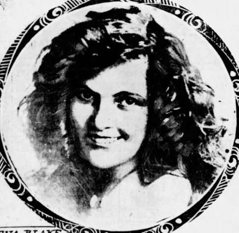 Nena Blake, a smiling white woman with  long dark curly hair, in a circle frame