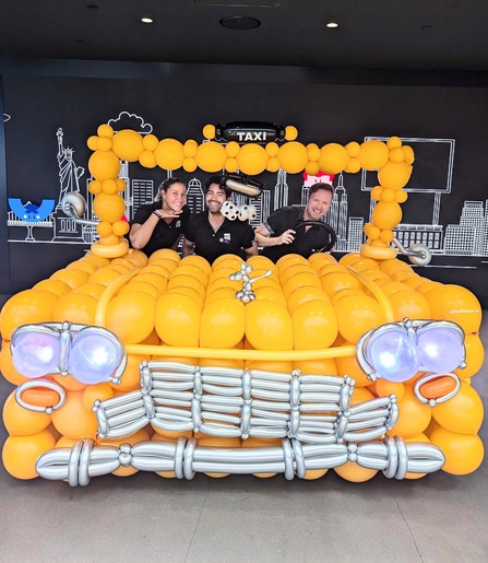 Me and my work besties in a yellow taxi made of balloons
