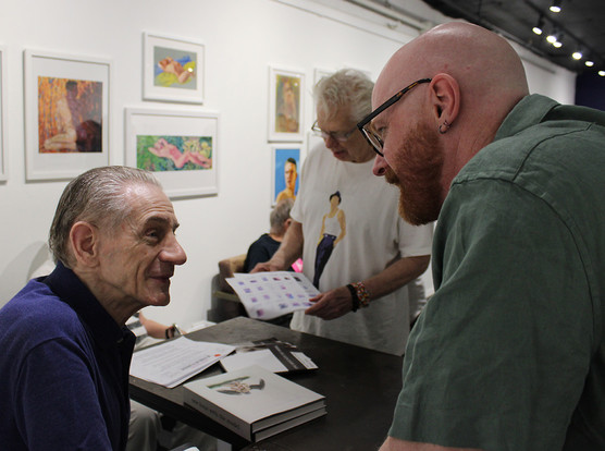 a photograph of me speaking to Rob Hugh Rosen the curator of the We Stand With Ukraine exhibition