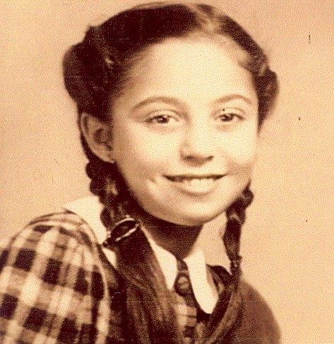 Vintage portrait of a girl smiling, with her hair in braids.
