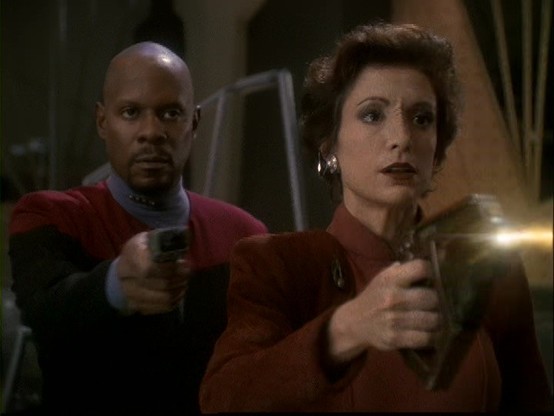 Kria and Sisko use phasers to defend Ops during the Klingon Attack in 