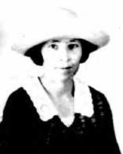 1922 passport photo of Anne Harwick, a young white woman wearing a brimmed cap and a dark top with a white lace collar