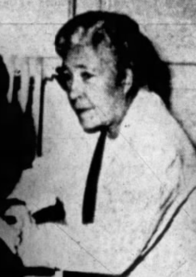 Anne Harwick in mid-life, working as a social worker at a sanatorium in Virginia; a white woman with greying hair, wearing a white lab coat