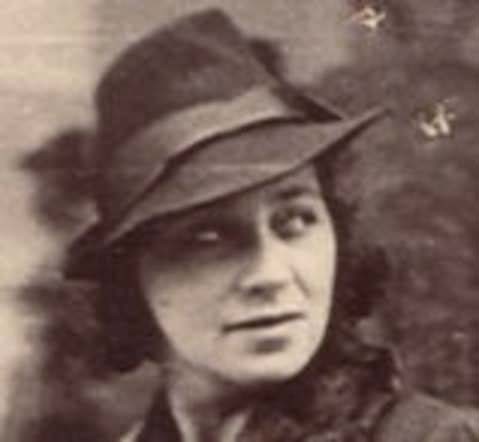 Vintage black and white portrait of a woman wearing a fedora hat and a serious expression.
